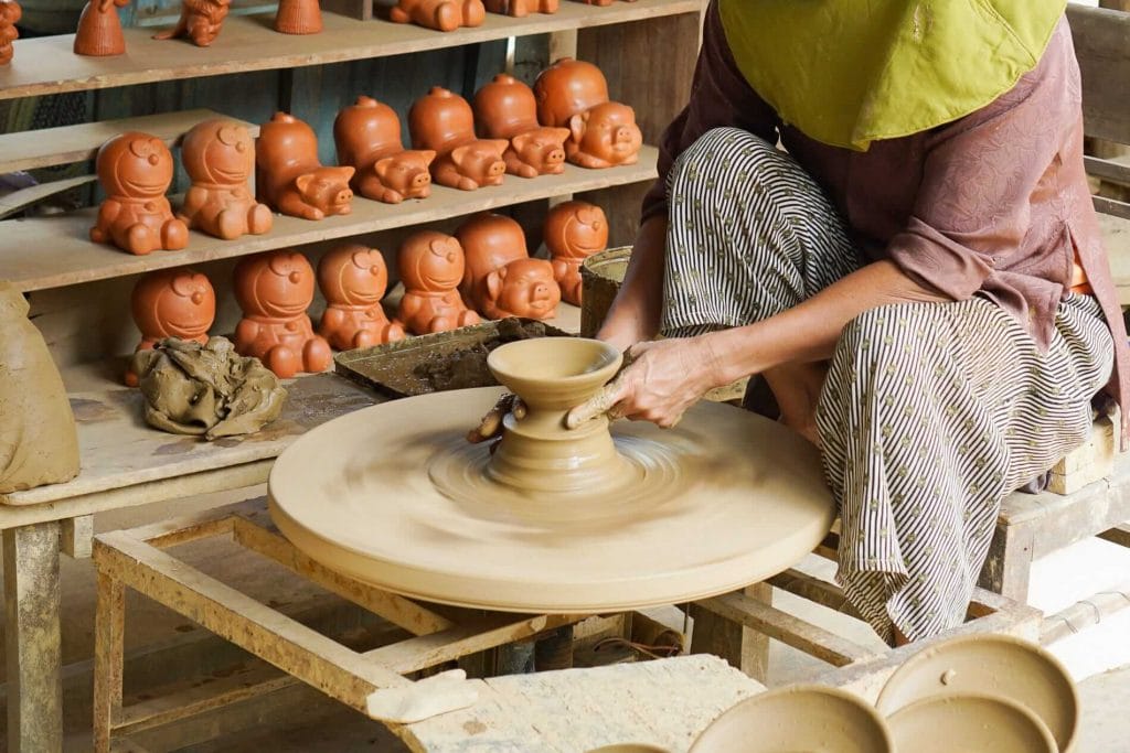 A mixture of hand throwing on a potters wheel and hand building techniques