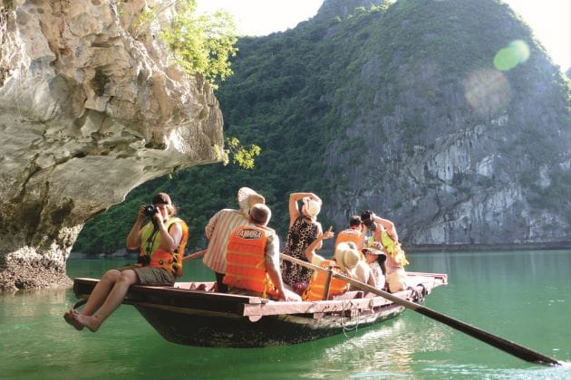 Luxury Family Holidays Vietnam: Your Guide to Unforgettable Family Adventures 4 family-cave-exploring-on-boat